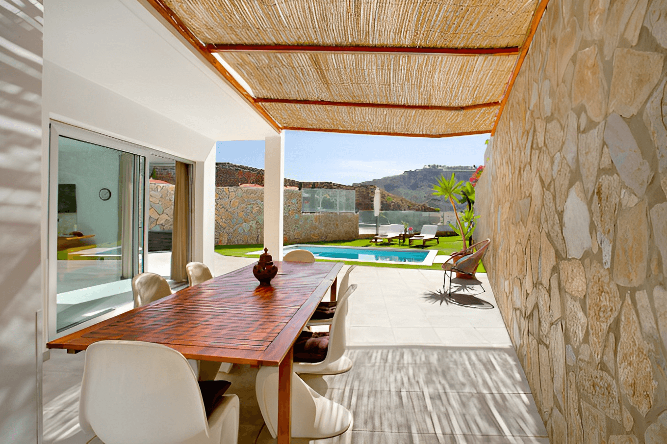 Covered dining terrace beside the pool