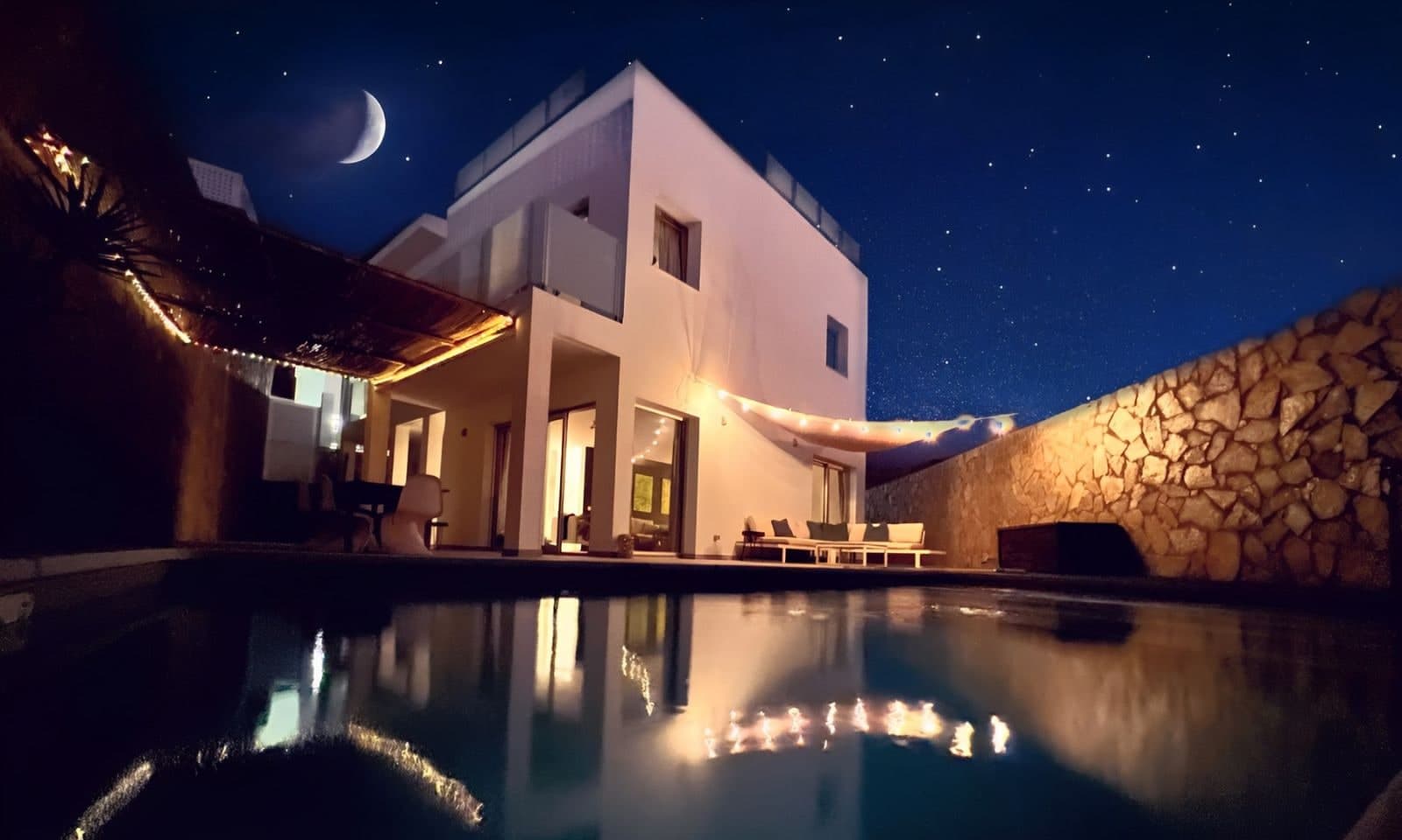Casa Tilda at night, the pool lit up under the stars