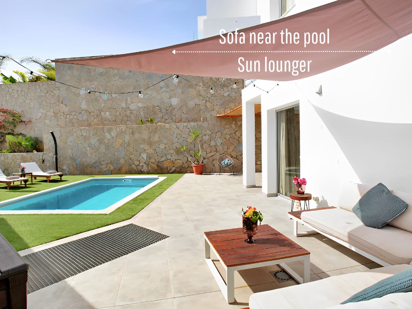 Pool lounge with sun loungers and shade sail